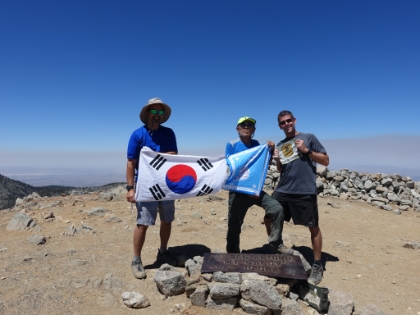 As I was hanging-out on the summit, along came 79 year old super-hiker Seuk Kim again sumitting Baldy for the 11th day in a row. He insisted on another summit pic with our "flags". This time he gifted me an apple, some sort of Korean vegetable, and some gummy worms. All I had to gift him back was a raw, organic power bar and some water (he was running low). I hung out for almost an hour and half chatting with him before heading back down.