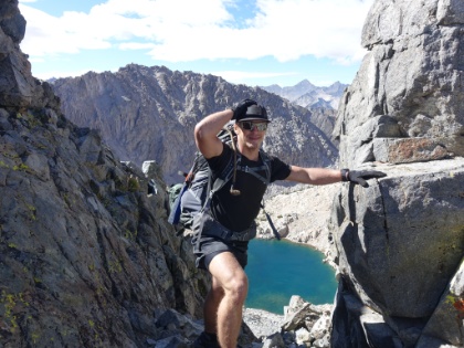 Made it! Glen Pass at 11,978' above sea level. As soon as you hit the pass, there's a gap in the rocks with an incredible view down the other side. The wind is also howling through the gap. According to my trusty Kestrel meter, the gusts are around 40mph. They're enough to blow off anything not firmly attached to your body and enough to knock you off your feet if you're not bracing yourself. And the temperature is about 35 degrees.