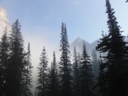 The peaks above the mist. I break down camp and get ready to head out. My tent was covered in mud from the storm the night before, so I had to wash it in the creek and dry it in the sun before packing up. Fortunately the morning was warm and clear.