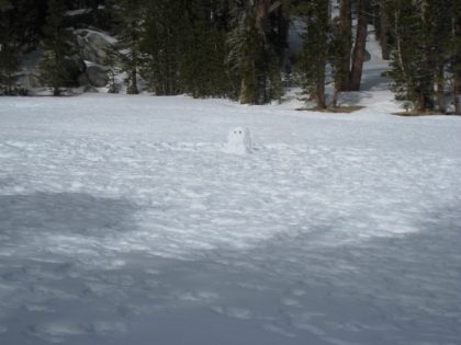 I make it to the meadows at Round Valley, a popular backpacking camp site. This snowman would be a very welcome sight on the way back.