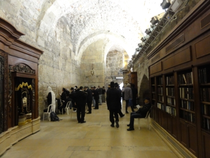 The Western Wall continues in tunnels along the wall. There are several alcoves with religious texts used by those praying here. Jews will place their foreheads and one palm on the wall for long periods of time. Many of them have a headband with a bumper on it to make this easier.