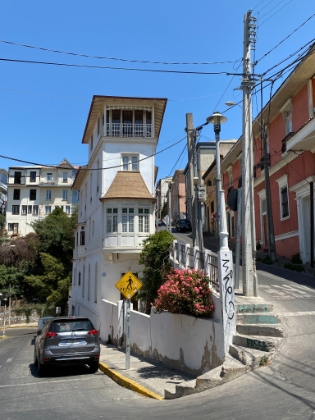 A very skinny house between two steep streets.