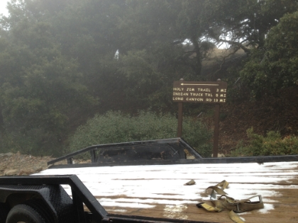 As we approached the summit, a light rain started, which turned into a heavy rain, which then turned into sleet/hail, which then turned into full on snow. By the time we reached the summit, there were big fluffy snowflakes in the air. It was cold enough that the snow was actually starting to stick, as seen here.