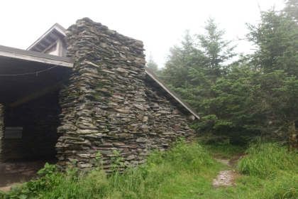 The elevation listed on the lodge sign was the summit elevation, not the actual elevation of the lodge. So I decided to continue on for a ways until I hit the official 6,593' elevation. There's a backpacking shelter at that point. I stopped and chatted with some backpackers there for a while. And then the clouds burst and a torrential downpour started. Great. I had almost 6 miles to go to get back, it was already 3:30pm, it was pouring rain with thunder and lighting, on a trail I wasn't familiar with, and it was just me left on the trail. It was the most fun I had all trip!