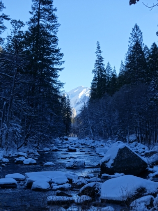 Looking down the Merced River at a heavily snow covered Clouds Rest in the distance.